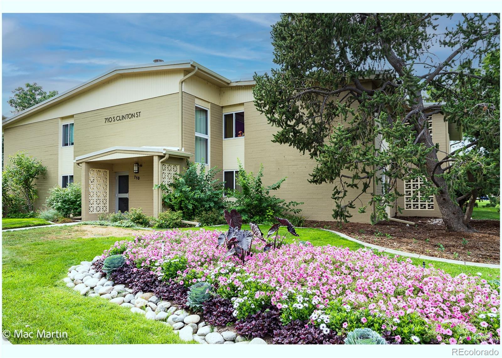 710 South Clinton Street, Unit 6B Denver, CO 80247 - Photo 17 of 31 a front view of a house with a yard