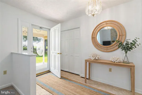 a view of a bedroom with a window and a mirror