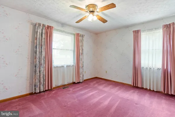 a view of an empty room with a fireplace