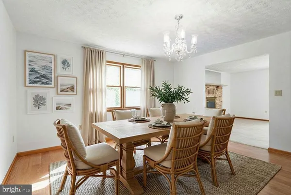 a dining room with furniture potted plants and wooden floor