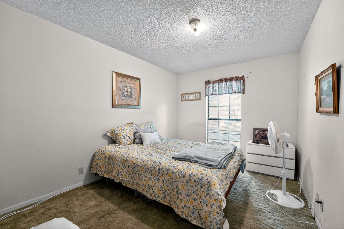 324 McClendon Drive Elgin, TX 78621 - Photo 2 of 16 a bedroom with a bed and a window