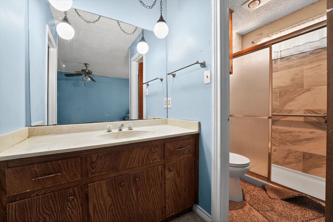 324 McClendon Drive Elgin, TX 78621 - Photo 3 of 16 a bathroom with a sink a toilet and shower