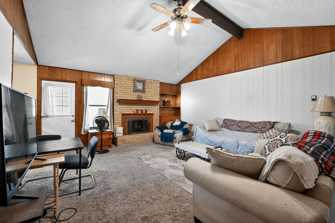 324 McClendon Drive Elgin, TX 78621 - Photo 6 of 16 a living room with furniture a fireplace and a large window