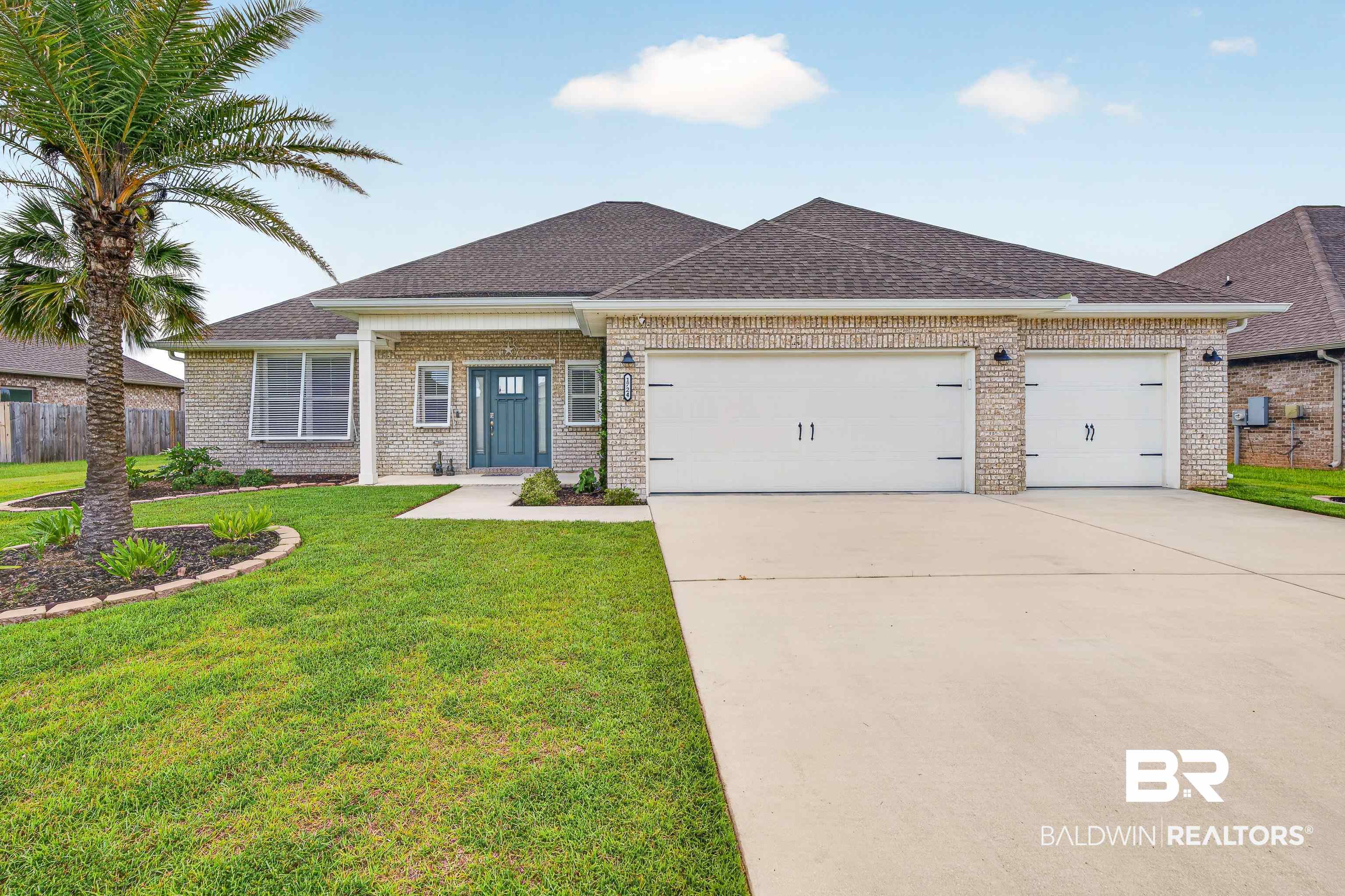 1724 Partridge Street Foley, AL 36535 - Photo 5 of 62 Single-story residence featuring light-colored brick veneer, a dark shingle roof, and a prominent palm tree