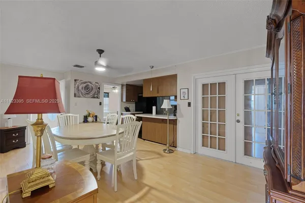 a dining room with furniture and a kitchen view
