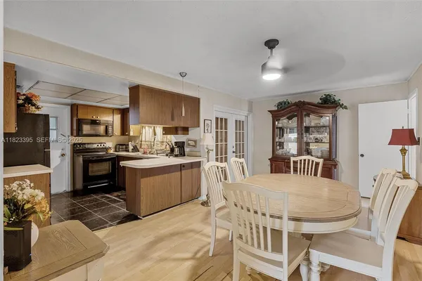 a kitchen with granite countertop kitchen island stainless steel appliances a sink stove and refrigerator