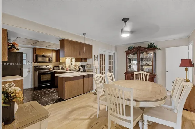 a kitchen with granite countertop kitchen island stainless steel appliances a sink stove and refrigerator