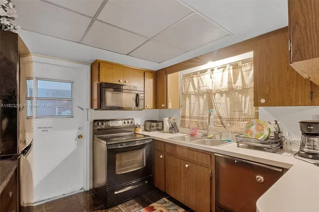 a kitchen with a sink stove and microwave