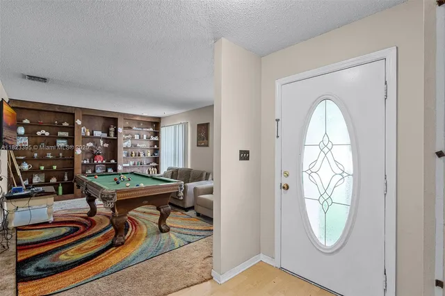 a view of a room with furniture and wooden floor