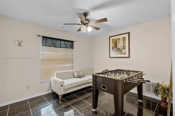 a bedroom with a table and a window