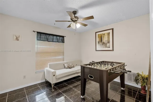 a bedroom with a table and a window