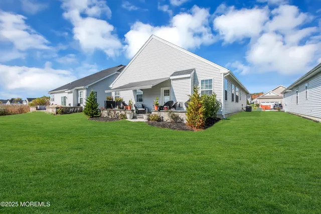 a view of an house with backyard space and garden
