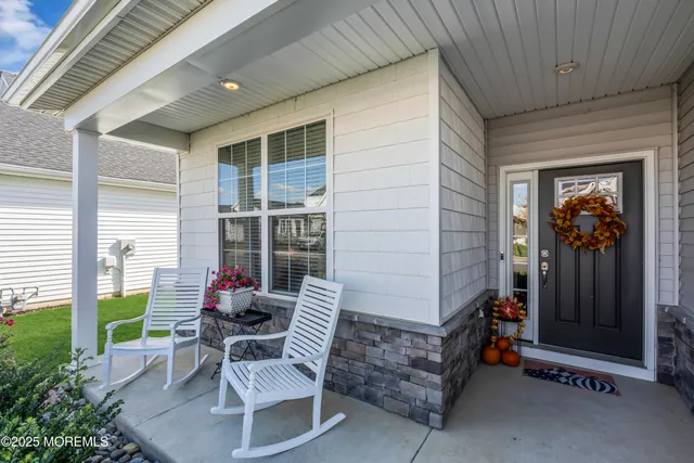 a view of a porch with chairs and backyard