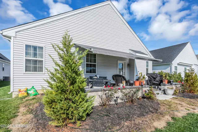 a view of a house with sitting area and garden