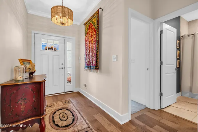 a view of an entryway with wooden floor