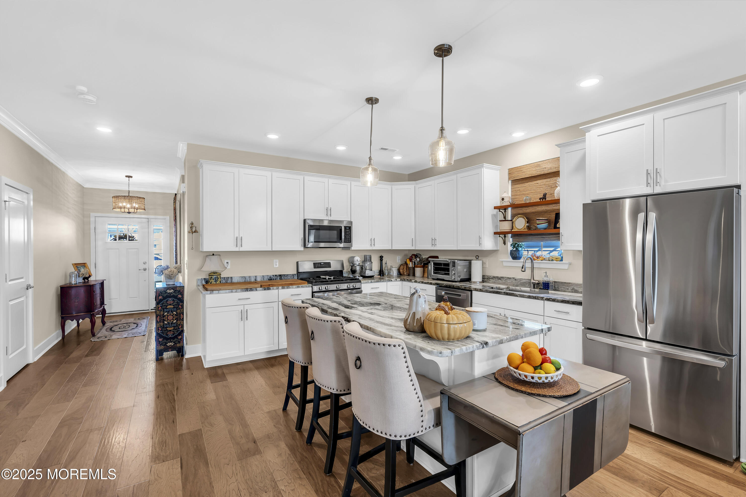 35 Saratoga Road New Egypt, NJ 08533 - Photo 7 of 41 a kitchen with a refrigerator a stove top oven a sink dishwasher and white cabinets with wooden floor