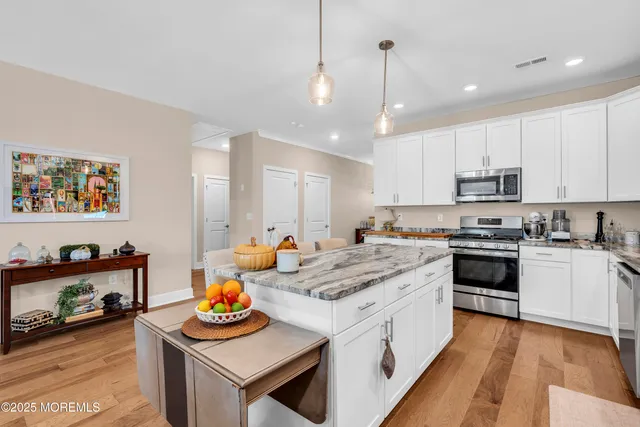 a kitchen with a stove a sink and a refrigerator