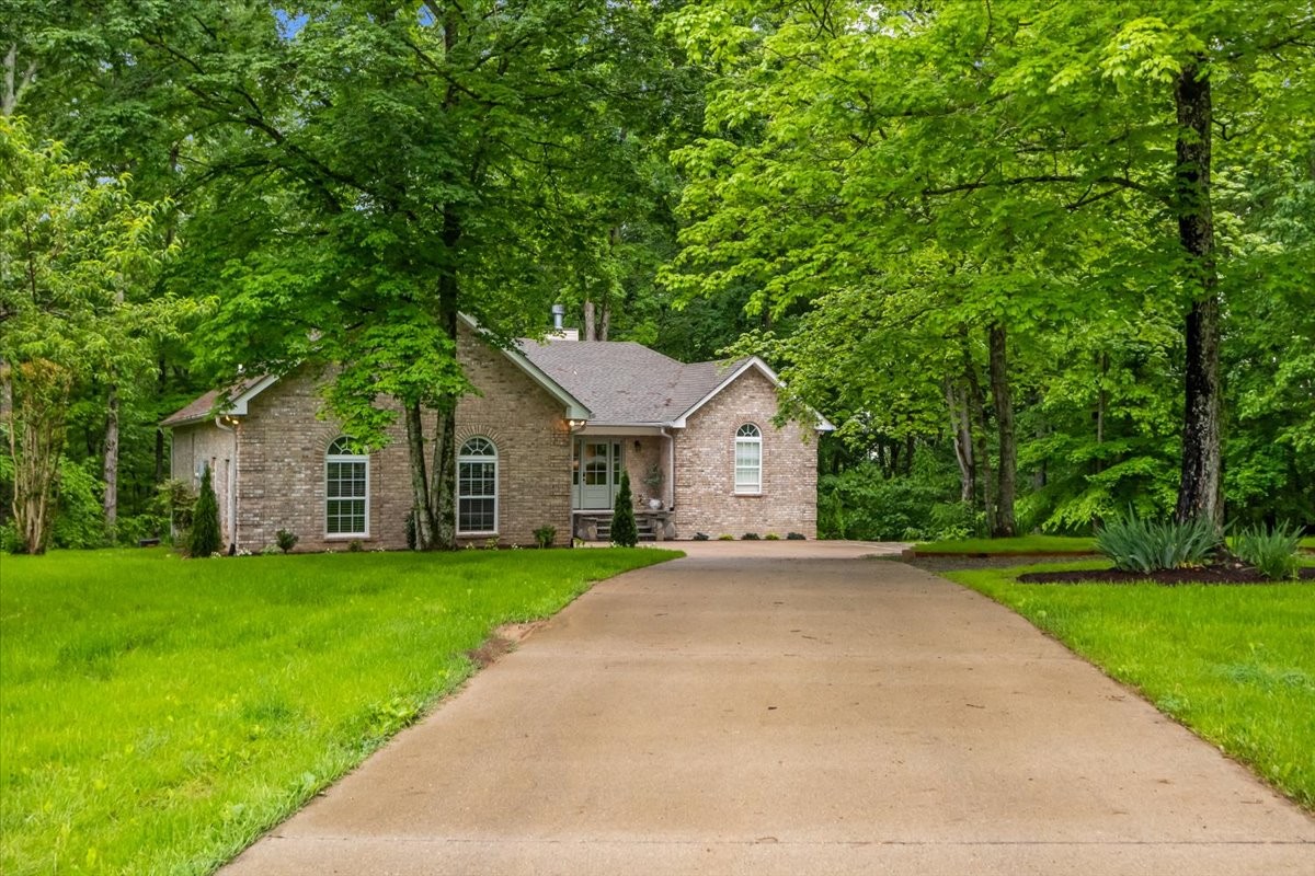 7327 Hunting Camp Road Fairview, TN 37062 - Photo 66 of 83 a front view of a house with a yard and trees