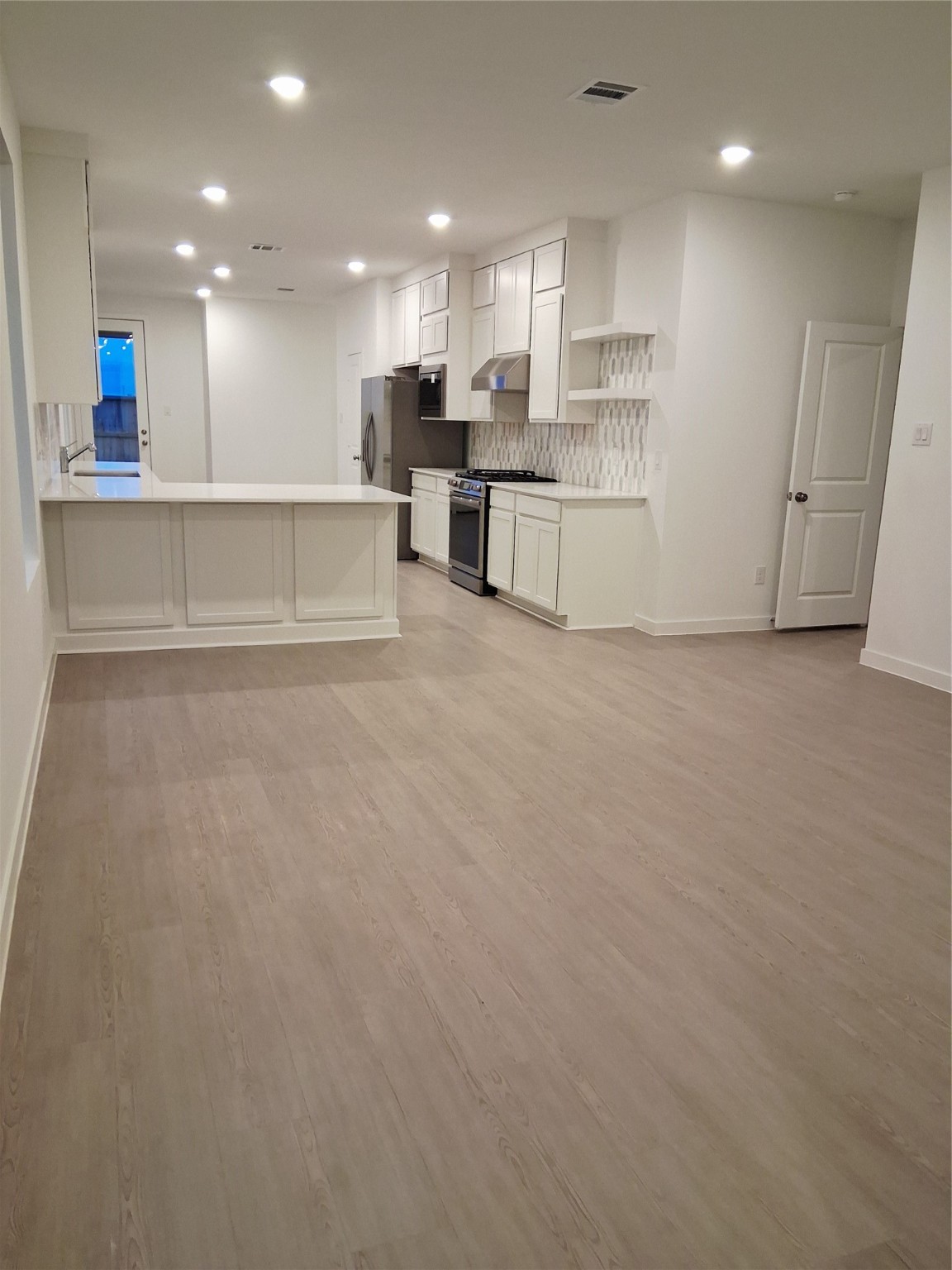 1047 Blue Stone Drive Beasley, TX 77417 - Photo 3 of 11 a view of kitchen with kitchen island white cabinets and refrigerator