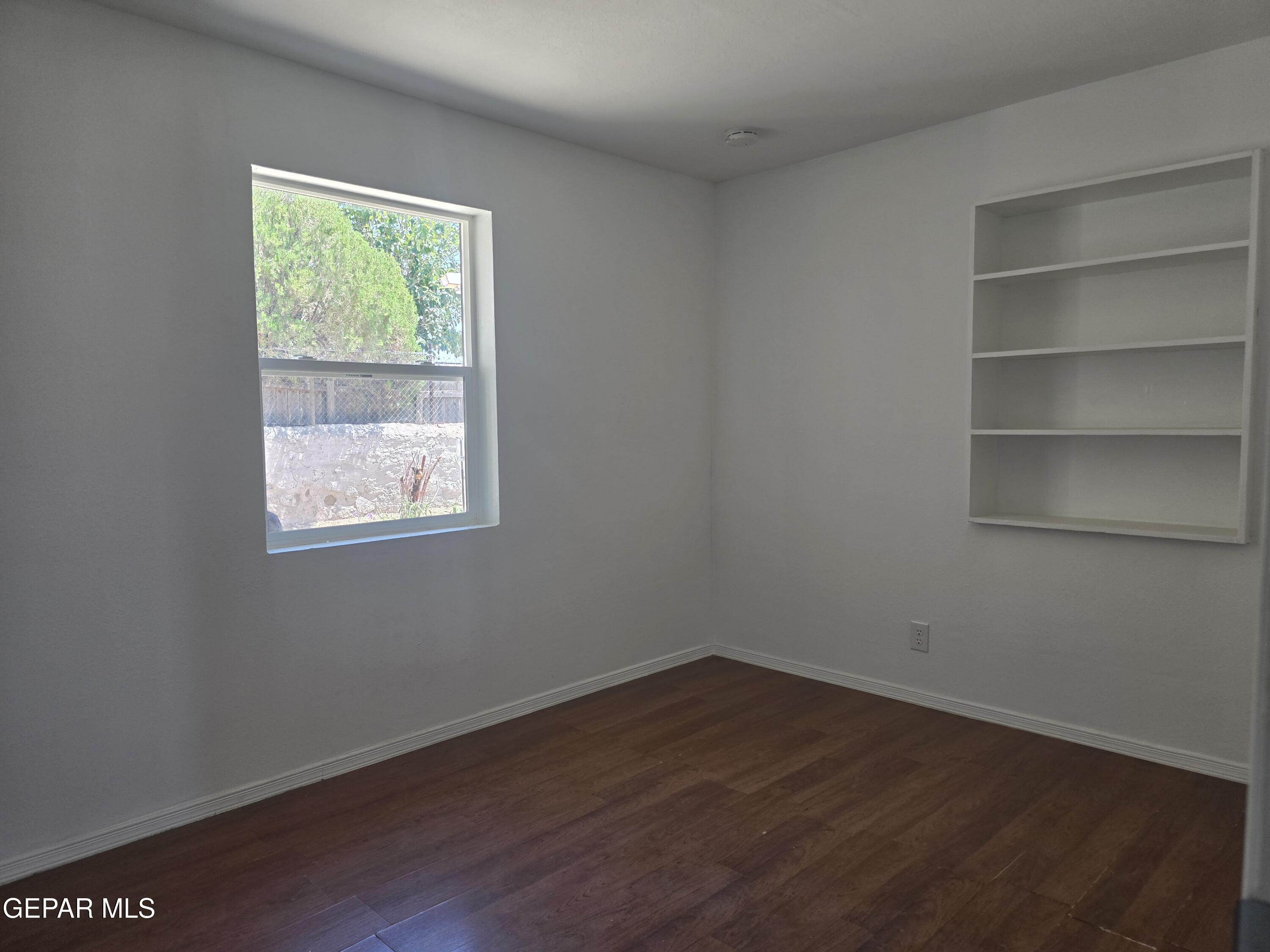 226 Coronado Road El Paso, TX 79915 - Photo 16 of 22 a view of a room that has wooden floor and a window