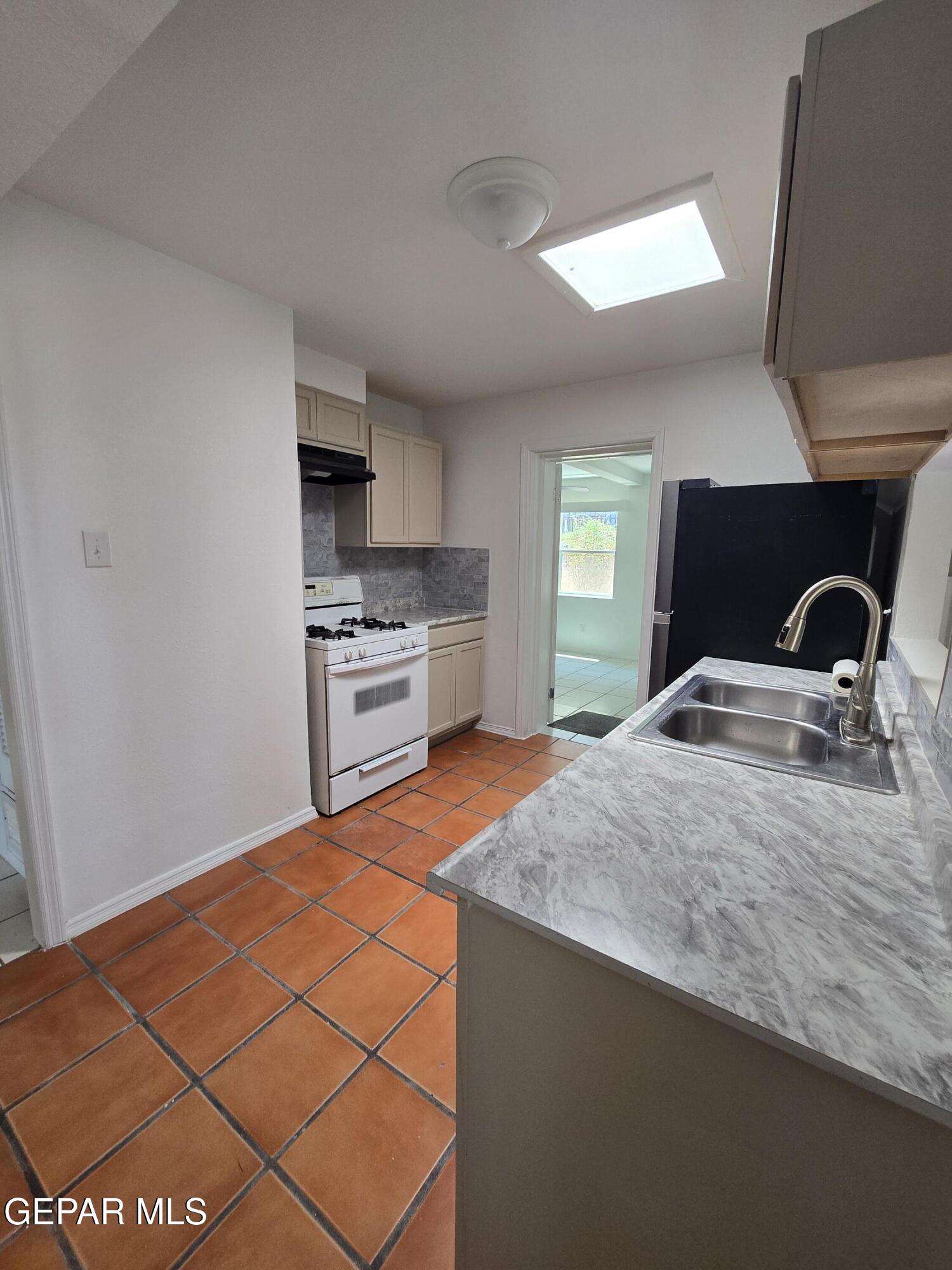 226 Coronado Road El Paso, TX 79915 - Photo 8 of 22 a kitchen with a sink and a stove top oven