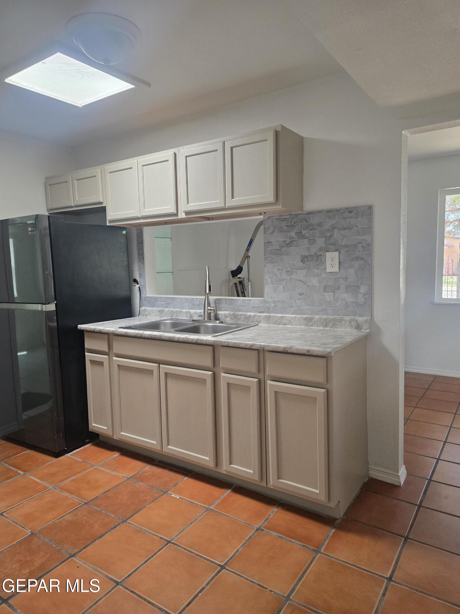 226 Coronado Road El Paso, TX 79915 - Photo 10 of 22 a kitchen with stainless steel appliances granite countertop a sink stove and refrigerator