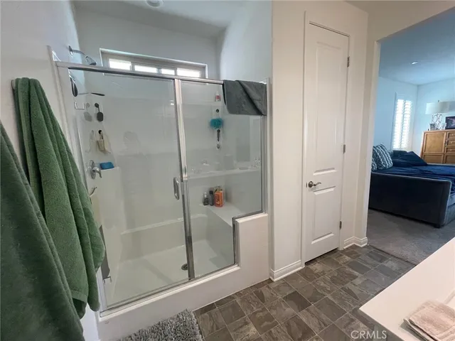 a bathroom with a glass shower door and a sink