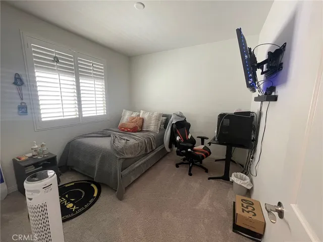 a bedroom with furniture and a window