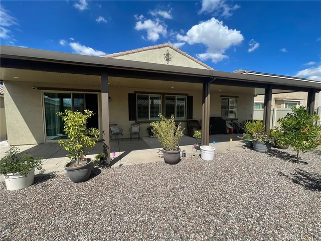 a view of a house with sitting area and potted plants