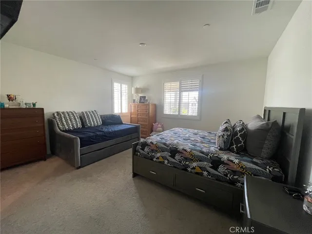 a bedroom with bed and window