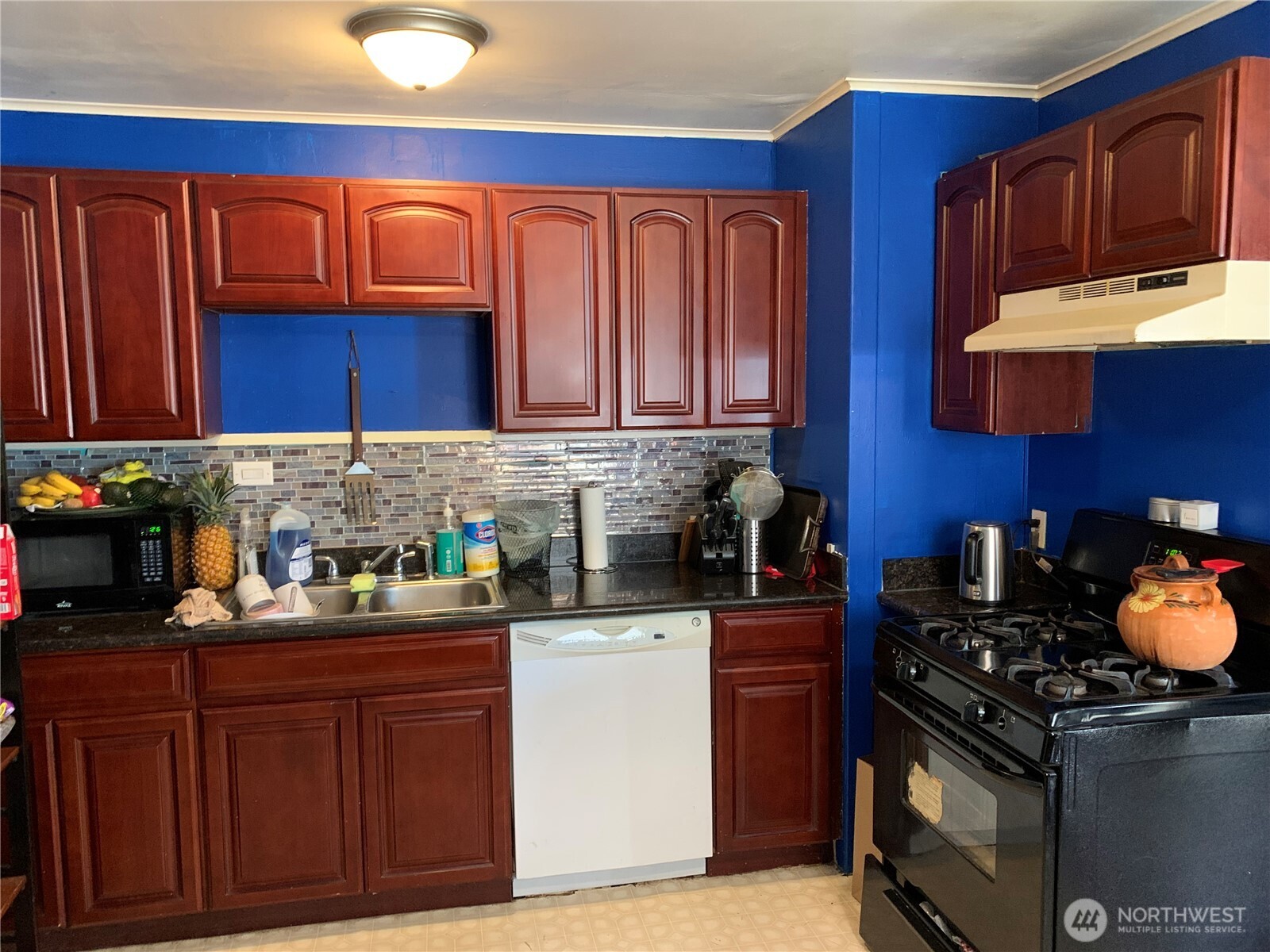 632 Index Avenue Northeast Renton, WA 98056 - Photo 6 of 13 a kitchen with stainless steel appliances granite countertop a stove top oven a sink dishwasher and cabinets with wooden floor