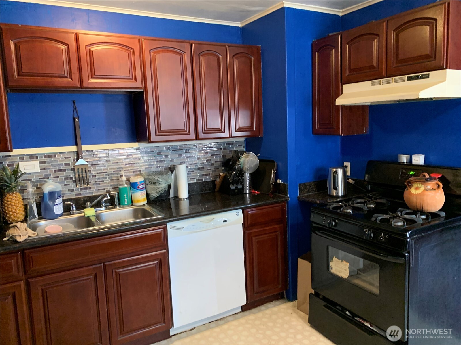 632 Index Avenue Northeast Renton, WA 98056 - Photo 9 of 13 a kitchen with stainless steel appliances granite countertop a stove top oven a sink dishwasher and cabinets with wooden floor