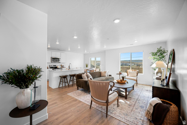 2123 Wolverine Way, Unit 2437 Washington, UT 84780 - Photo 15 of 40 Open-concept living space featuring wood-finish flooring, recessed lighting, and large windows