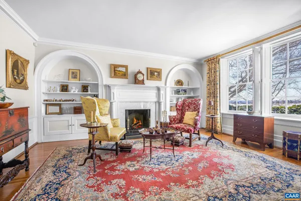a view of a livingroom with wooden floor and a fireplace