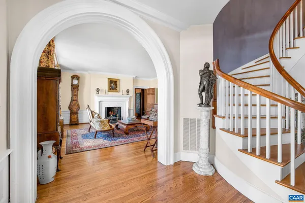 a living room with furniture a rug and a fireplace