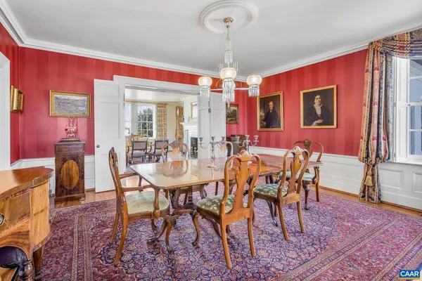 a kitchen with stainless steel appliances granite countertop a table chairs sink refrigerator and microwave