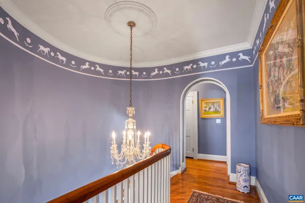 a bedroom with a large bed a flat tv screen and dresser