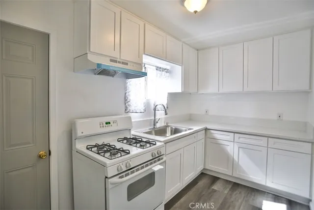a kitchen with cabinets appliances a sink and a counter top