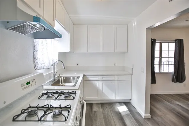 a kitchen with a stove and a white cabinet