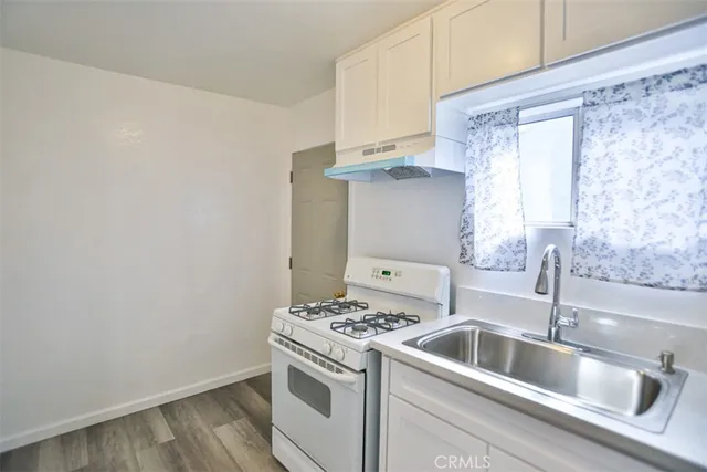 a kitchen with a sink and a stove top oven