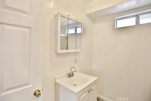 a bathroom with a glass shower door