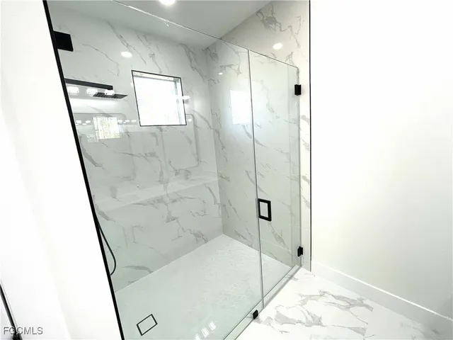 a bathroom with double vanity sink and a mirror