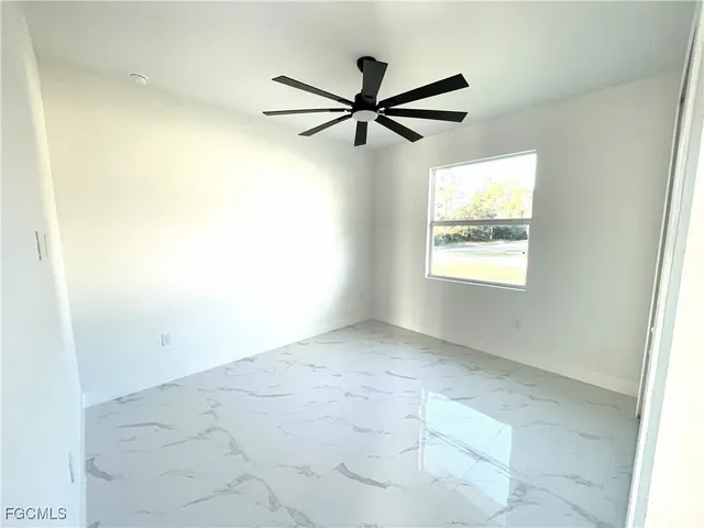 a view of room with a ceiling fan and window
