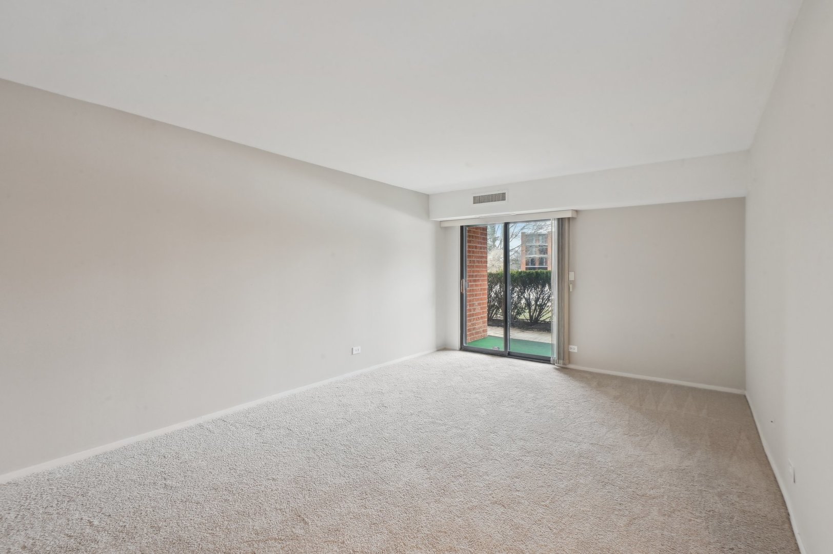 1615 East Central Road, Unit 121C Arlington Heights, IL 60005 - Photo 12 of 23 a view of an empty room with window and closet area