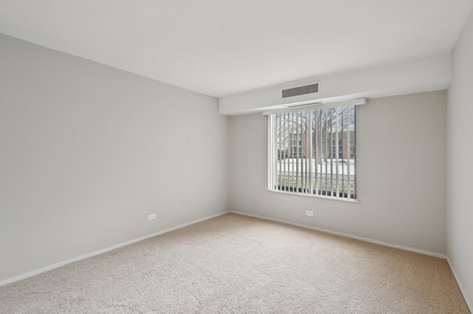 1615 East Central Road, Unit 121C Arlington Heights, IL 60005 - Photo 18 of 23 a view of an empty room with a window