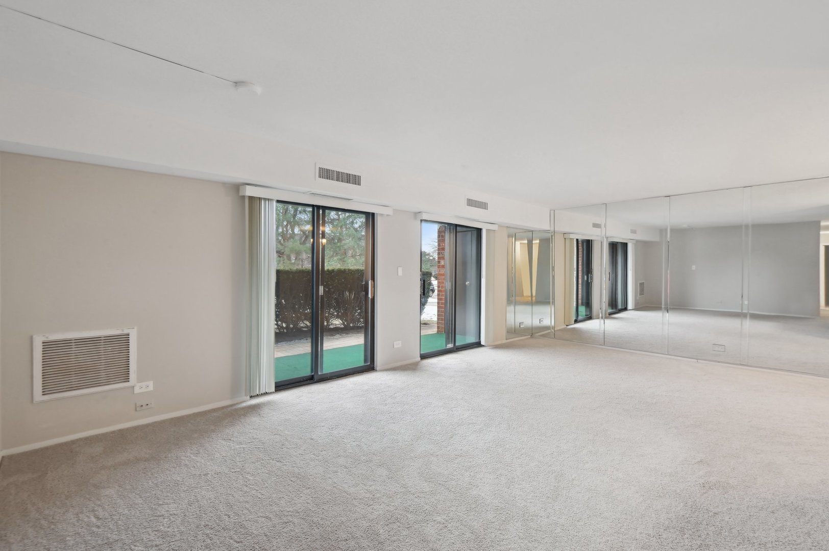 1615 East Central Road, Unit 121C Arlington Heights, IL 60005 - Photo 3 of 23 a view of a big room with windows and chandelier fan
