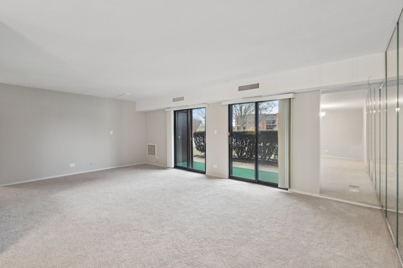 1615 East Central Road, Unit 121C Arlington Heights, IL 60005 - Photo 4 of 23 a view of an empty room with windows