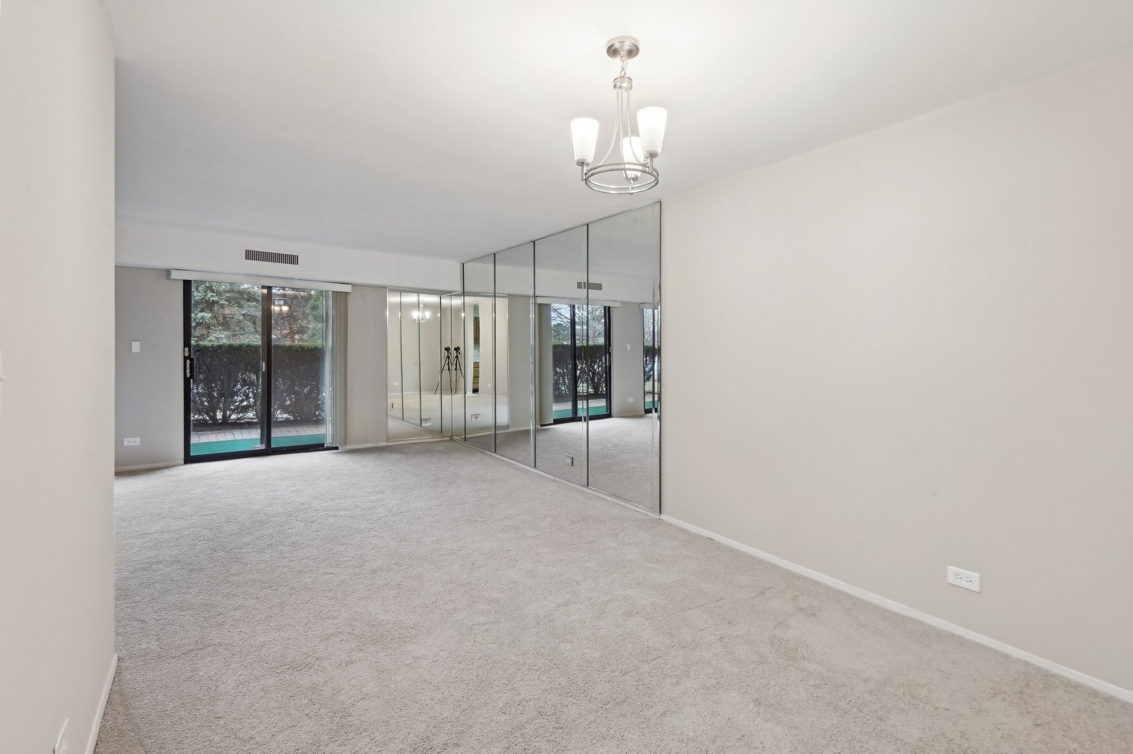 1615 East Central Road, Unit 121C Arlington Heights, IL 60005 - Photo 5 of 23 a view of an empty room with a chandelier