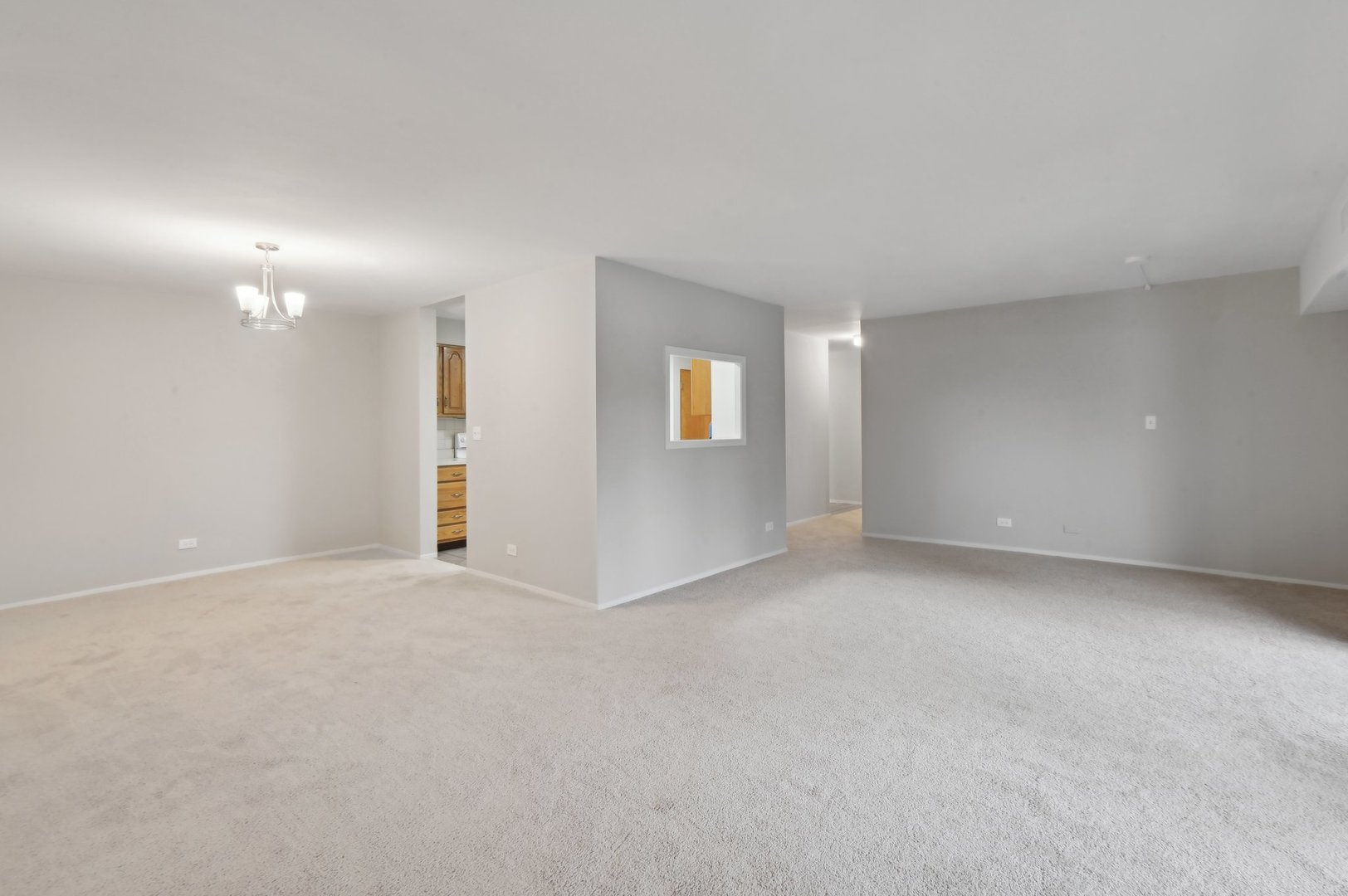 1615 East Central Road, Unit 121C Arlington Heights, IL 60005 - Photo 6 of 23 a view of an empty room with a window