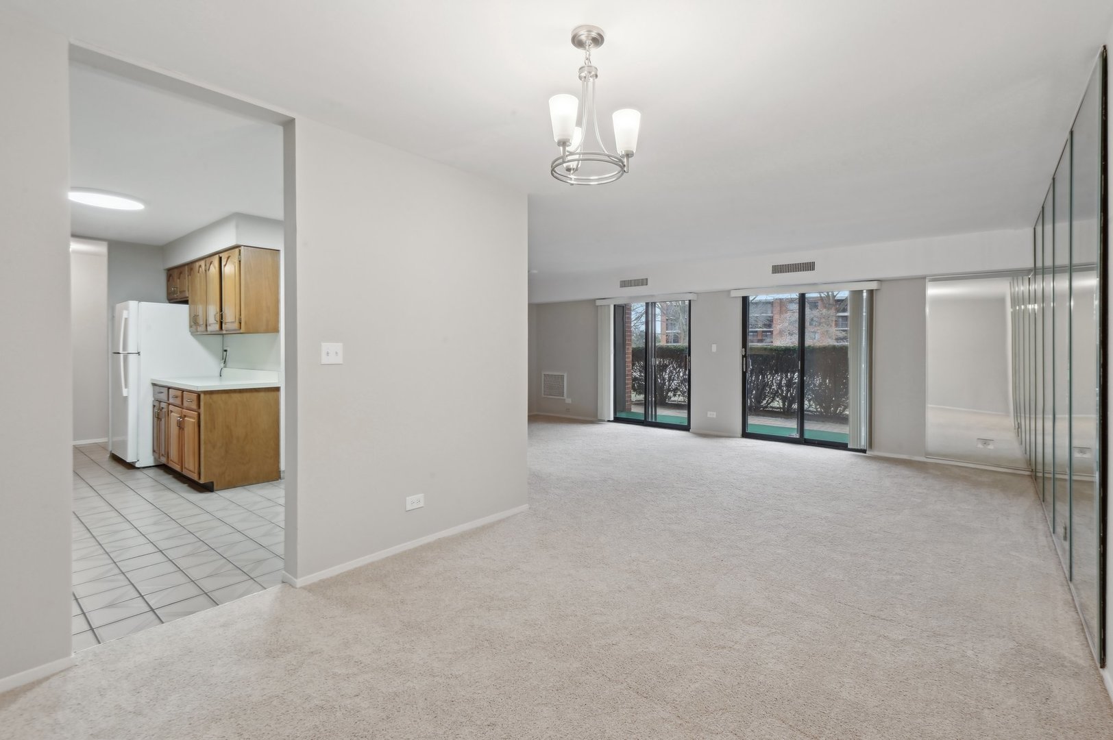 1615 East Central Road, Unit 121C Arlington Heights, IL 60005 - Photo 7 of 23 a view of a livingroom with furniture and chandelier fan